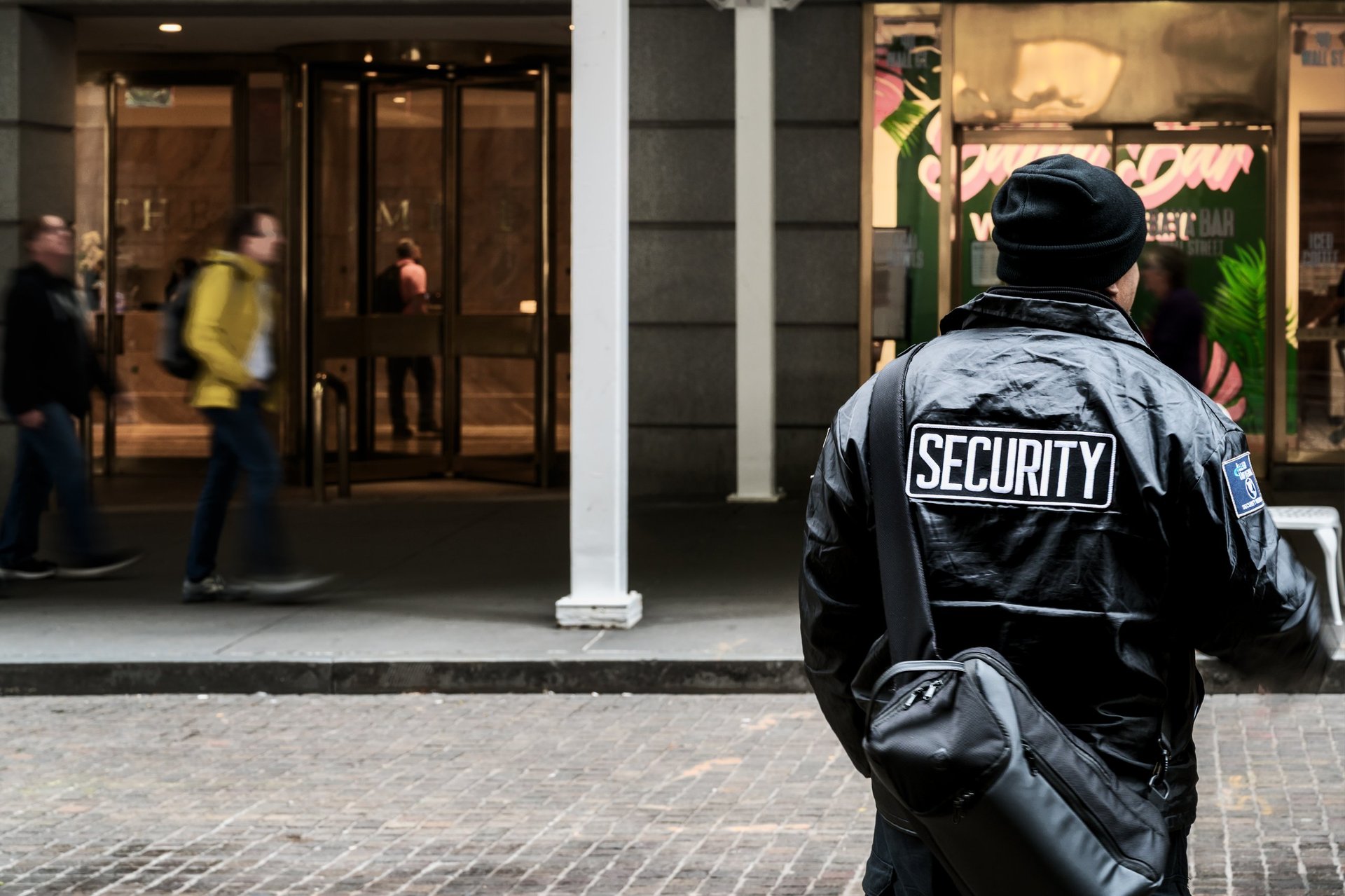 Professional security officer standing outside building