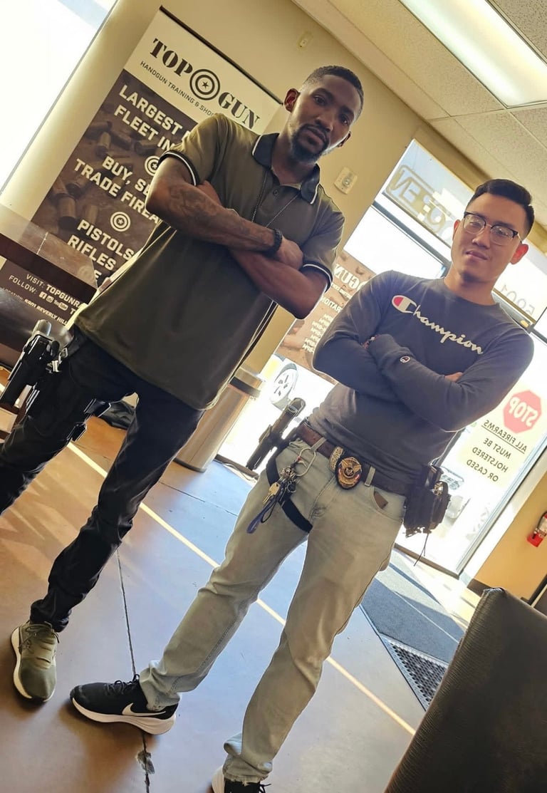 Two men in a barbershop, one holding a sign and one standing nearby, with salon decor and signage visible in background